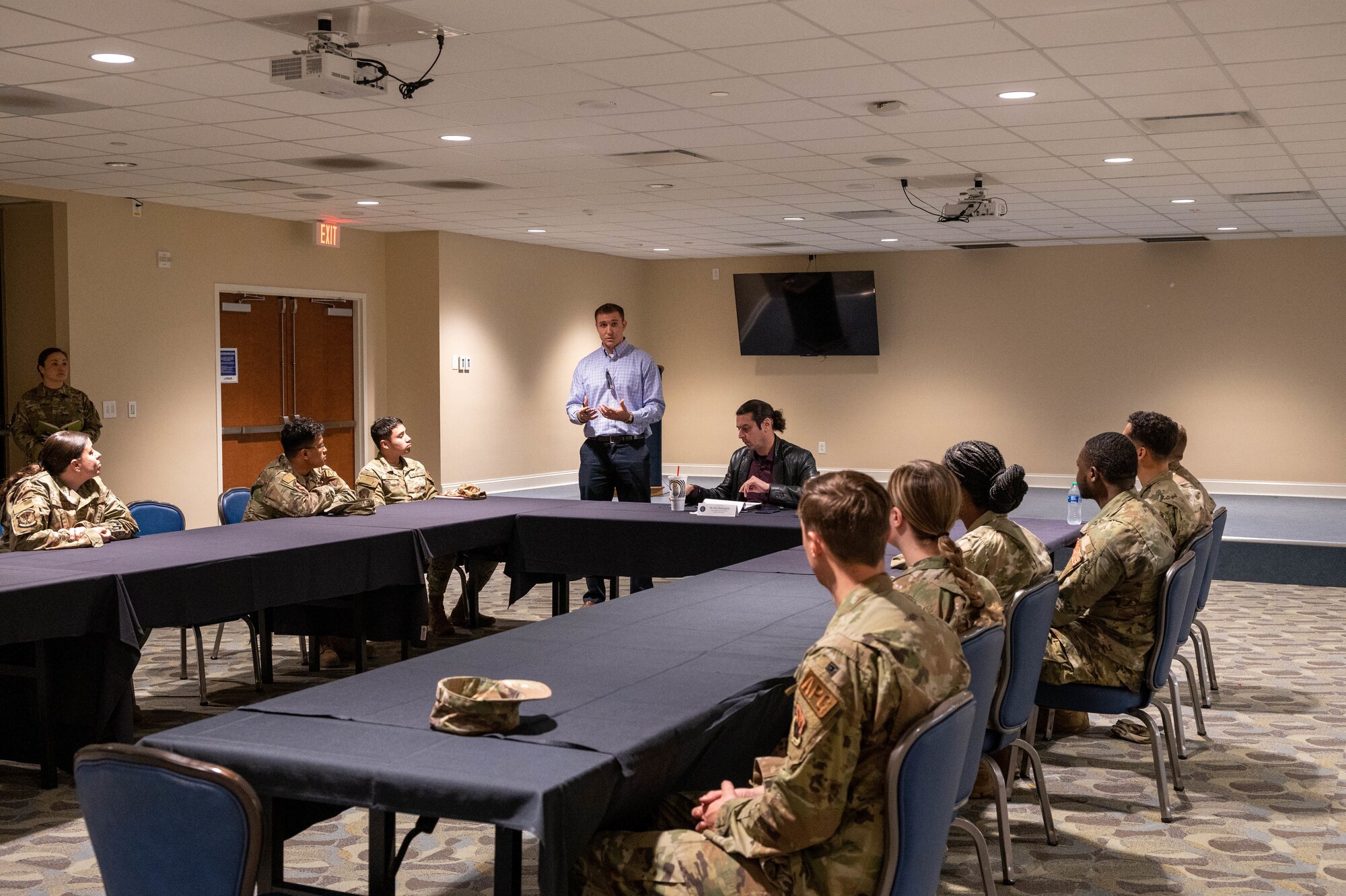 U.S. Army Capt. Tom Dickson welcomes Airmen assigned to the 4th Fighter Wing to a junior enlisted panel hosted by Kiya Batmanglidj, House Appropriations committee member, at Seymour Johnson Air Force Base, North Carolina, Feb. 23, 2023. The panel allowed participants to voice any concerns or challenges that impacted their quality of life. (U.S. Air Force photo by Senior Airman Taylor Hunter)