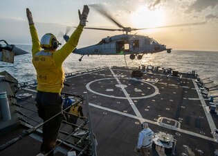 An MH-60S Sea Hawk helicopter from HSC-26 conducts deck landing qualifications aboard USS Paul Hamilton (DDG 60) in the Arabian Gulf.