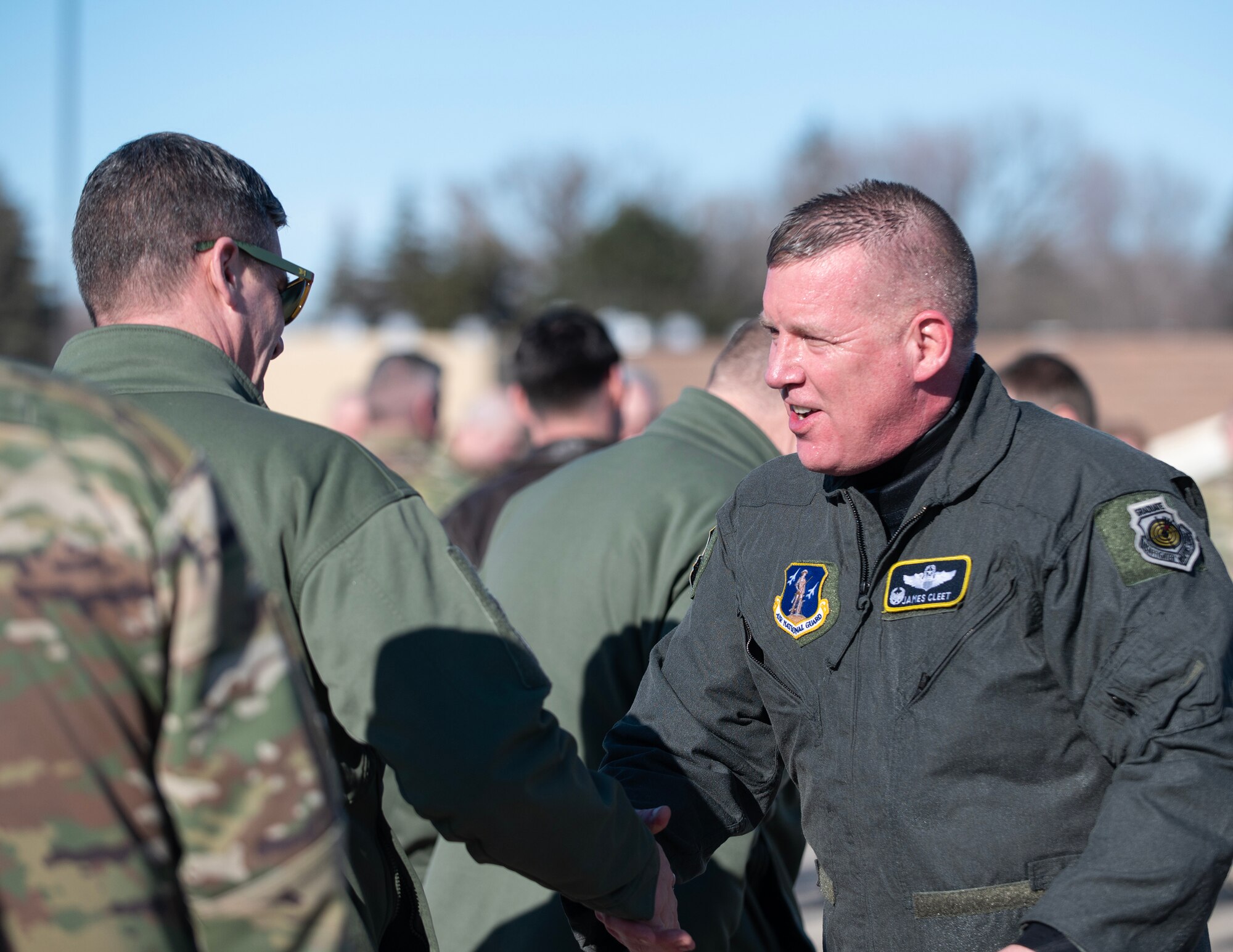 U.S. Air Force Airmen from the 133rd Airlift Wing congratulate U.S. Air Force Col. James Cleet after completing his fini-flight in St. Paul, Minn., Feb. 13, 2023