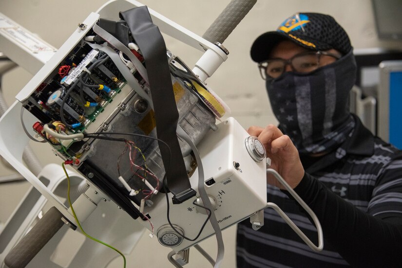 A biomedical equipment technician works on a portable X-ray machine at U.S. Army Medical Materiel Agency’s Medical Maintenance Operations Division at Tracy, California. (U.S. Army photo by Katie Ellis-Warfield/Released)