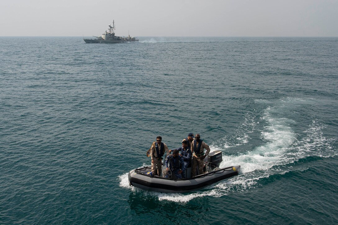 230226-N-NH267-1065 ARABIAN GULF (Feb. 26, 2023) Members of Bahrain’s armed forces ride a small boat from RBNS Ahmad Al Fateh (P20) to guided-missile destroyer USS Paul Hamilton (DDG 60) in the Arabian Gulf, Feb. 26, 2023. Paul Hamilton is deployed to the U.S. 5th Fleet area of operations to help ensure maritime security and stability in the Middle East region.