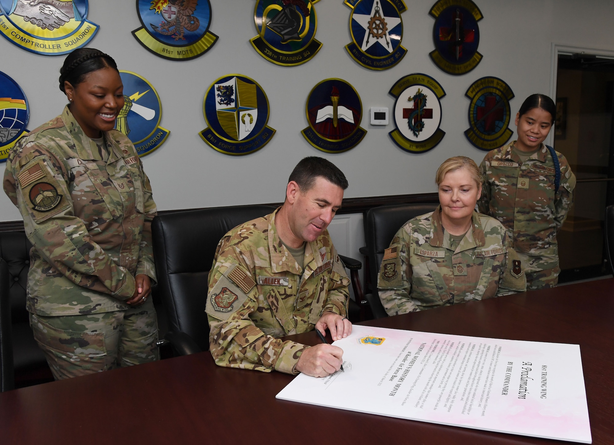 U.S. Air Force Col. Jason Allen, 81st Training Wing commander, signs the National Women's History Month Proclamation inside the 81st Training Wing headquarters building at Keesler Air Force Base, Mississippi, March 1, 2023.