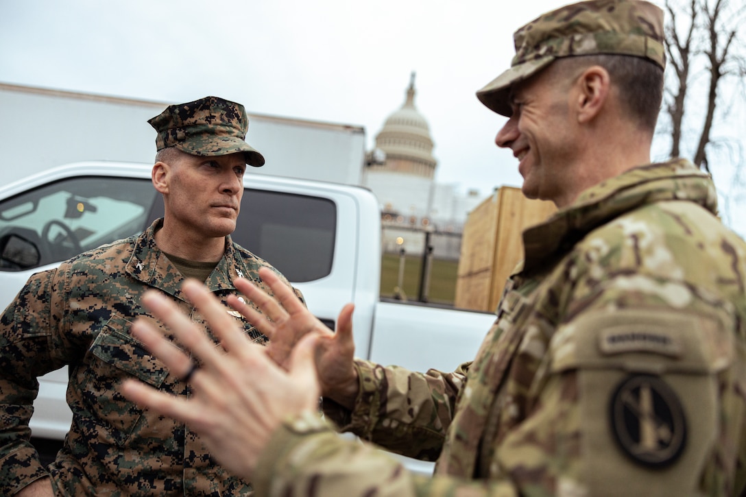 U.S. Marine Corps Col. Dean Schulz, commanding officer, with Chemical Biological Incident Response Force (CBIRF) speaks to U.S. Army Maj. Gen. Allan Pepin, commanding general, with Joint Task Force North Capital Region while supporting the State of the Union Address at The Capitol Building in Washington D.C., Feb. 7, 2023. CBIRF’s support consists of coordination with the U.S. Capitol Police and U.S. Secret Service in the event of a chemical, biological, radiological, nuclear, or high-yield explosive incident during the Presidential Address. (U.S. Marine Corps photo by Lance Cpl. Angel G. Ponce)