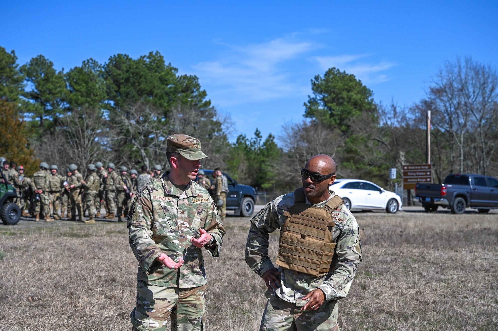 Two men in uniform talk to each other.