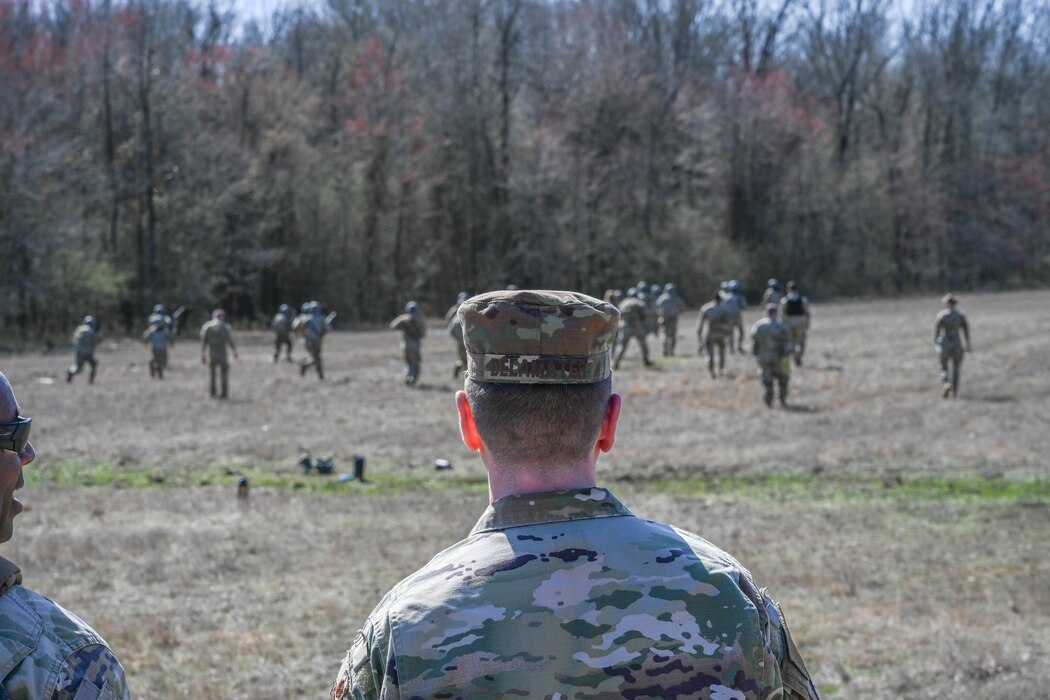 A man in uniform watches over a field.