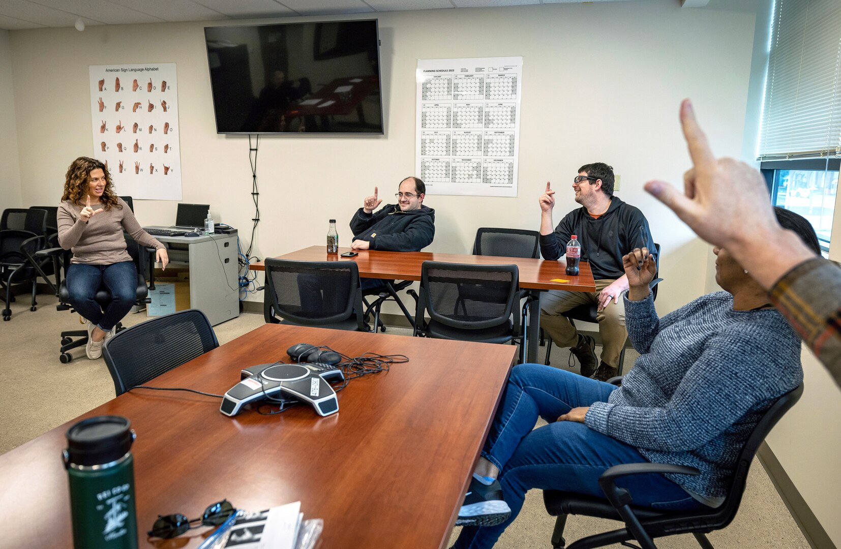 American Sign Language interpreter Marlene Bell, left, Jacob Lowe, painter, Shop 71, Painters, Blasters and Tilesetters, Brandon Salley, circuit breaker mechanic, Shop 51, Electricians, and Sheila Marks, personnel support specialist, Code 900A, lead a bi-monthly American Sign Language Lunch & Learn Feb. 2, 2023, in Building 435 at Puget Sound Naval Shipyard & Intermediate Maintenance Facility in Bremerton, Washington. (U.S. Navy photo by Scott Hansen)