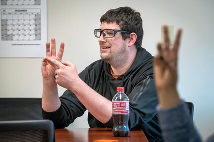 Brandon Salley, circuit breaker mechanic, Shop 51, Electricians, leads a bi-monthly American Sign Language Lunch & Learn Feb. 2, 2023, in Building 435 at Puget Sound Naval Shipyard & Intermediate Maintenance Facility in Bremerton, Washington. (U.S. Navy photo by Scott Hansen)