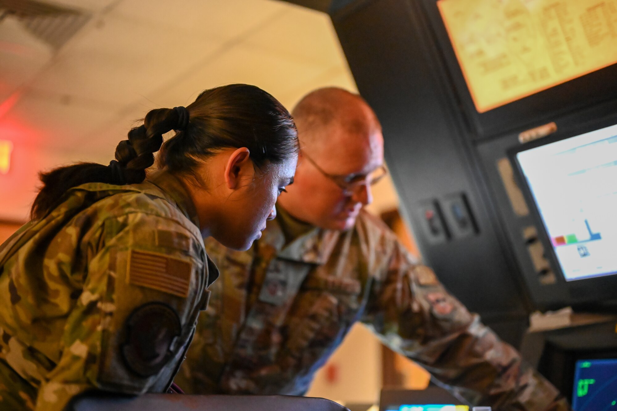 U.S. Air Force Airman 1st Class Natalie Bait (left), 47th Force Support Squadron career development technician, and Master Sgt. Todd Patino, 47th Operation Support Squadron chief tower controller, view a radar aircraft controller (RAPCON) screen at Laughlin Air Force Base, Texas, on Feb. 22, 2023.