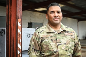 Air Force Staff Sgt. Carlos Hernandez-Garcia, aerospace ground equipment specialist assigned to the 103rd Airlift Wing, Connecticut Air National Guard, stands outside of the AGE facility at Bradley Air National Guard Base, Conn., October 23, 2022. On June 4, 2022 Hernandez-Garcia, who served as a Connecticut State Trooper, assisted a vehicle operator who was experiencing a near-fatal drug overdose while off-duty. (U.S. Air National Guard photo by Master Sgt. Tamara R. Dabney)