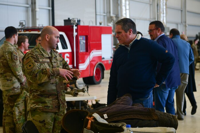 U.S. Air Force Staff Sgt. Nicholas Willet, 9th Security Forces Squadron K-9 handler, speaks with Rocco Greco, 9th Logistics Readiness Squadron honorary commander and Andros Karperos School principal, at the Honorary Commander immersion tour near the flight line at Beale Air Force Base, Calif., Feb. 24, 2023