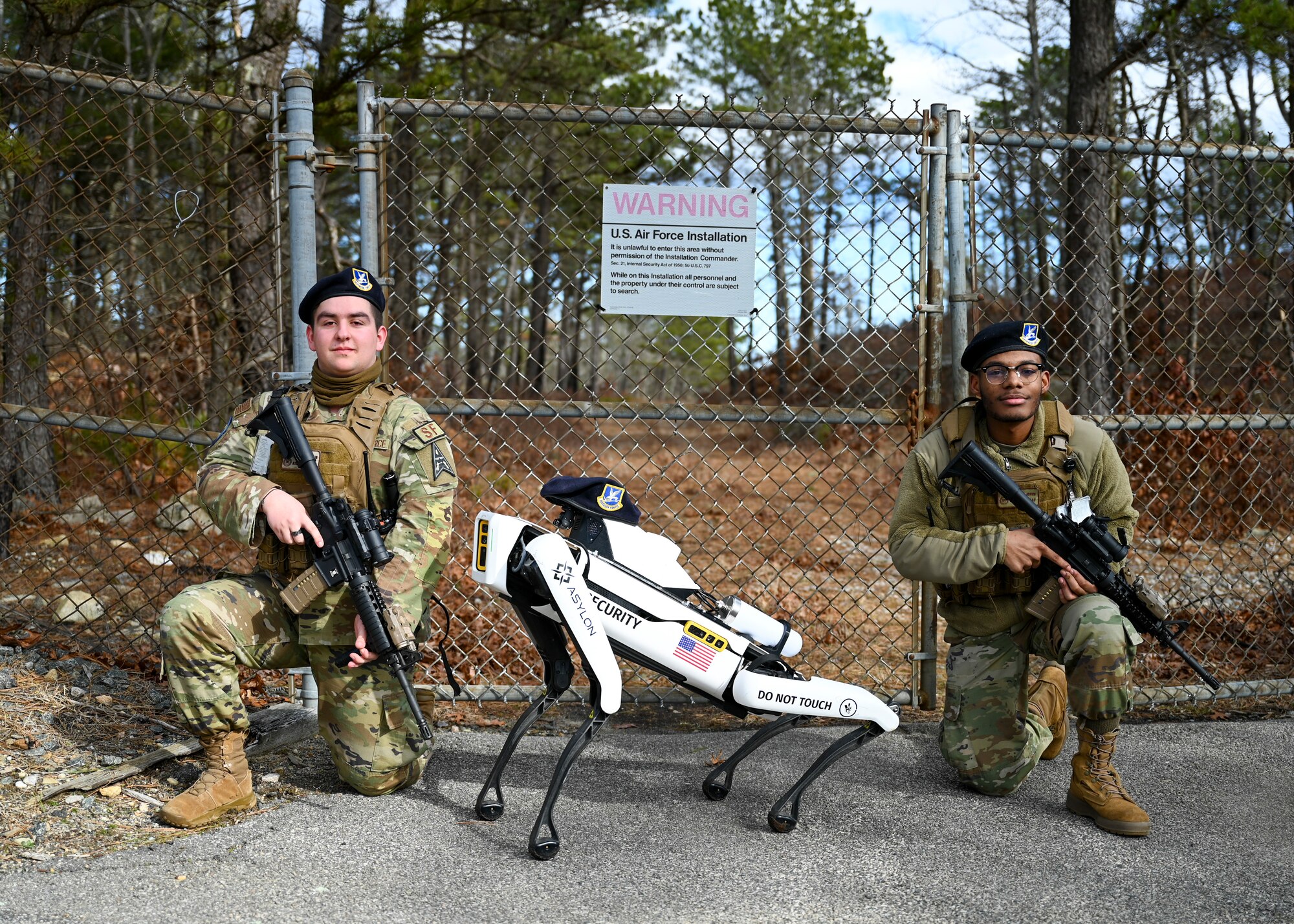 Robot Dog poses with two defenders