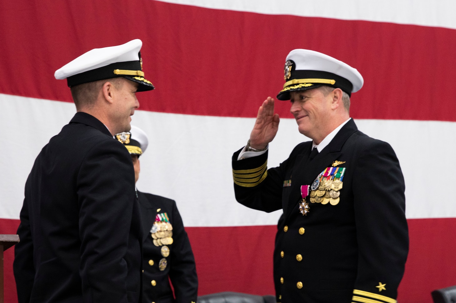 Capt. Geoffrey Hughes, Commander, Tactical Support Wing (CTSW), speaks at the CTSW change of command ceremony in the Fleet Logistics Support Wing (VR) 59 hangar at Naval Air Station Joint Reserve Base Fort Worth, Texas.