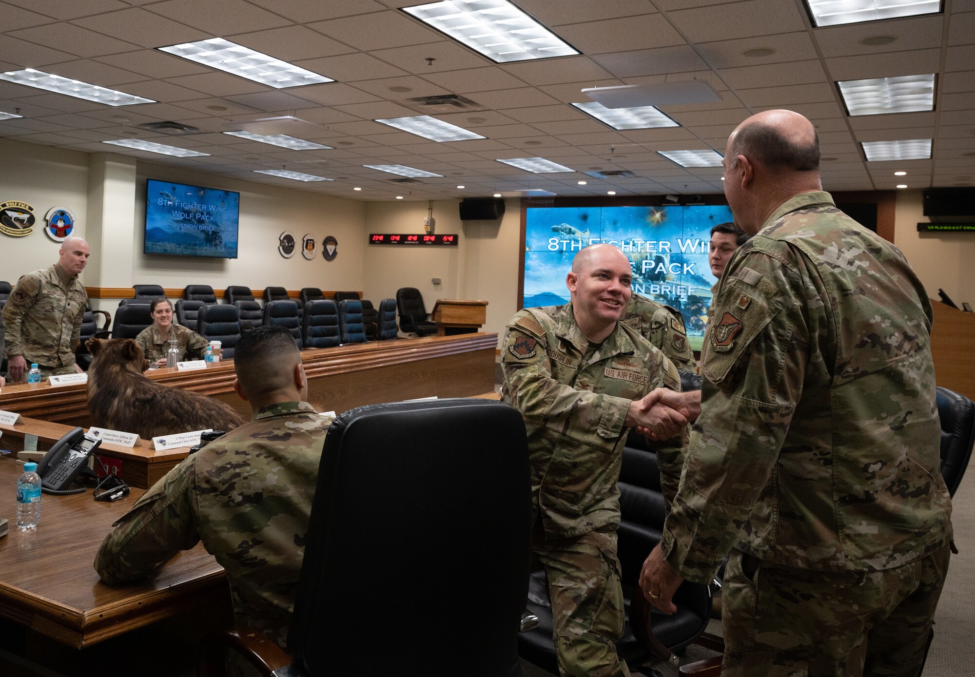 Col. Joseph Coughlin (center), 8th Mission Support Group commander, greets Col. Patrick Miller, Pacific Air Forces logistics, engineering and force protection director, at Kunsan Air Base, Republic of Korea, Feb. 28, 2023. The Wolf Pack’s group and squadron commanders provided insight on their unit’s mission and how they impacted the Indo-Pacific region. (U.S. Air Force photo by Staff Sgt. Sadie Colbert)