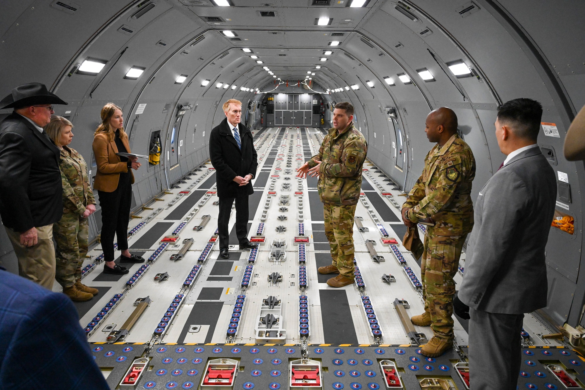U.S. Air Force Lt. Col. Teddy Boyd (center-right), 56th Air Refueling Squadron commander, talks about the KC-46 Pegasus with U.S. Sen. James Lankford of Oklahoma (center-left), at Altus Air Force Base, Oklahoma, Feb. 23, 2023. With more refueling capacity, improved efficiency and increased capabilities for cargo and aeromedical evacuation, the KC-46 provides aerial refueling support to the Air Force, Navy and Marine Corps. (U.S. Air Force photo by Senior Airman Trenton Jancze)