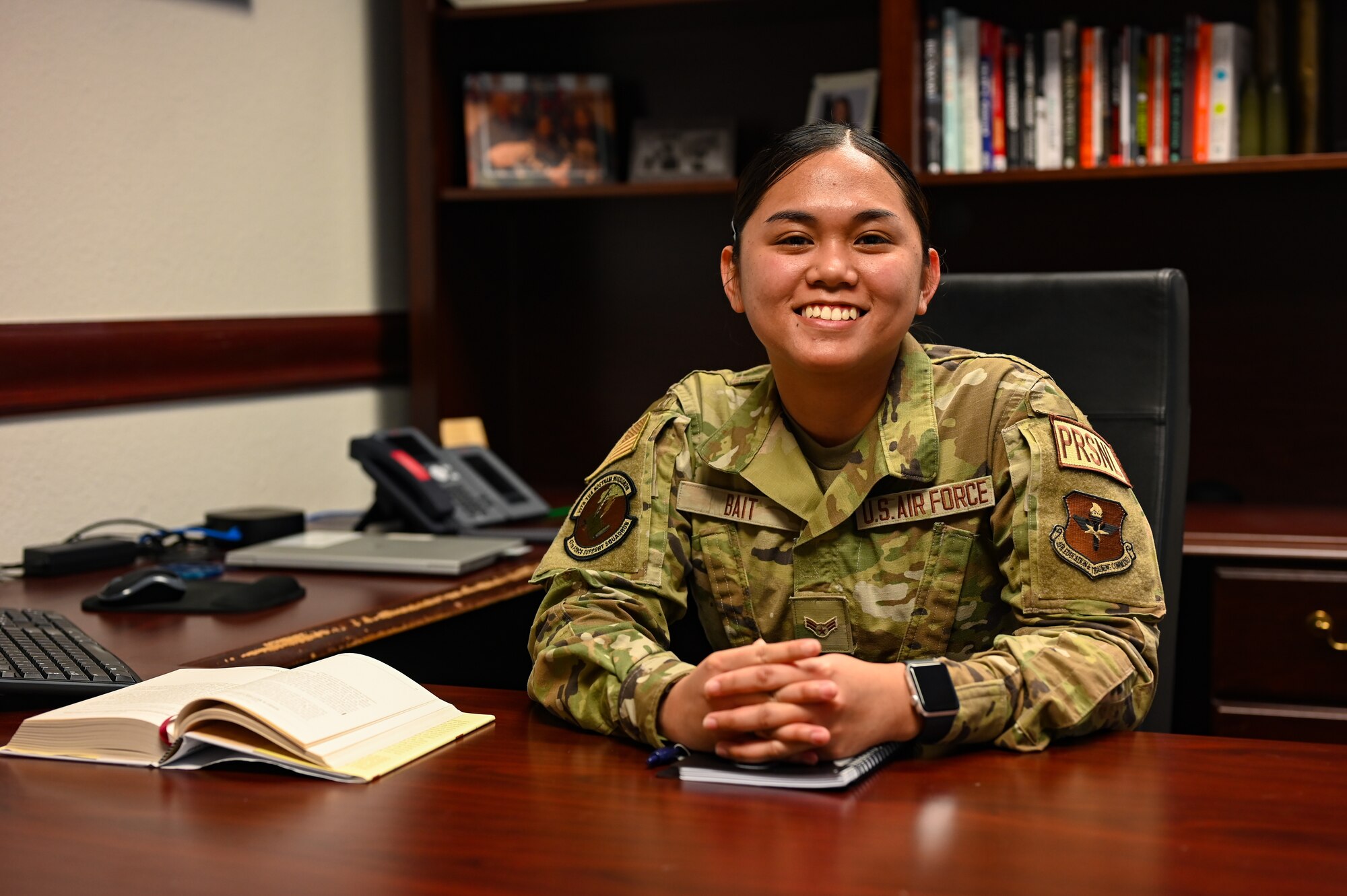 U.S. Air Force Airman 1st Class Natalie Bait, 47th Force Support Squadron career development technician, poses for a photo at Chief Master Sgt. David Snarr’s, 47th Flying Training Wing command chief, desk at Laughlin Air Force Base, Texas, on Feb. 22, 2023.