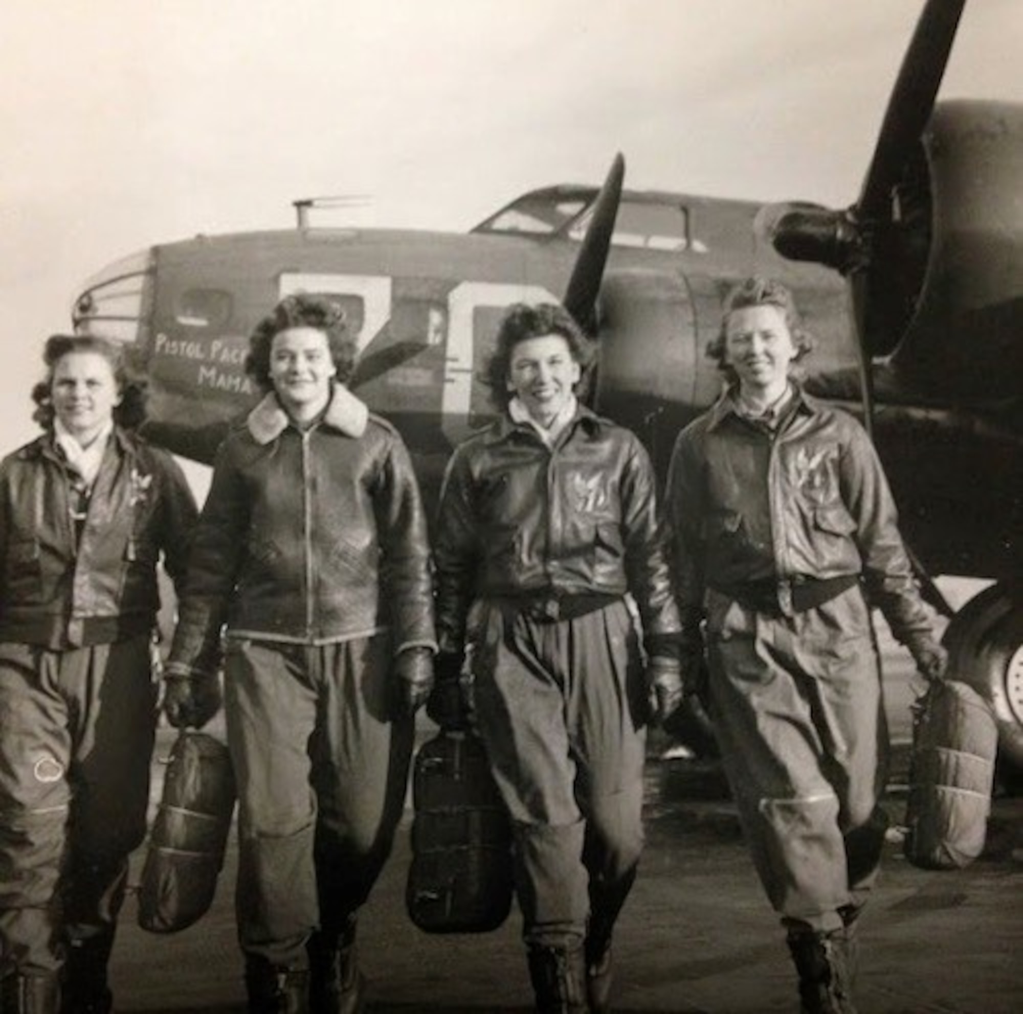 Four female WASPs walk toward camera, circa 1940s
