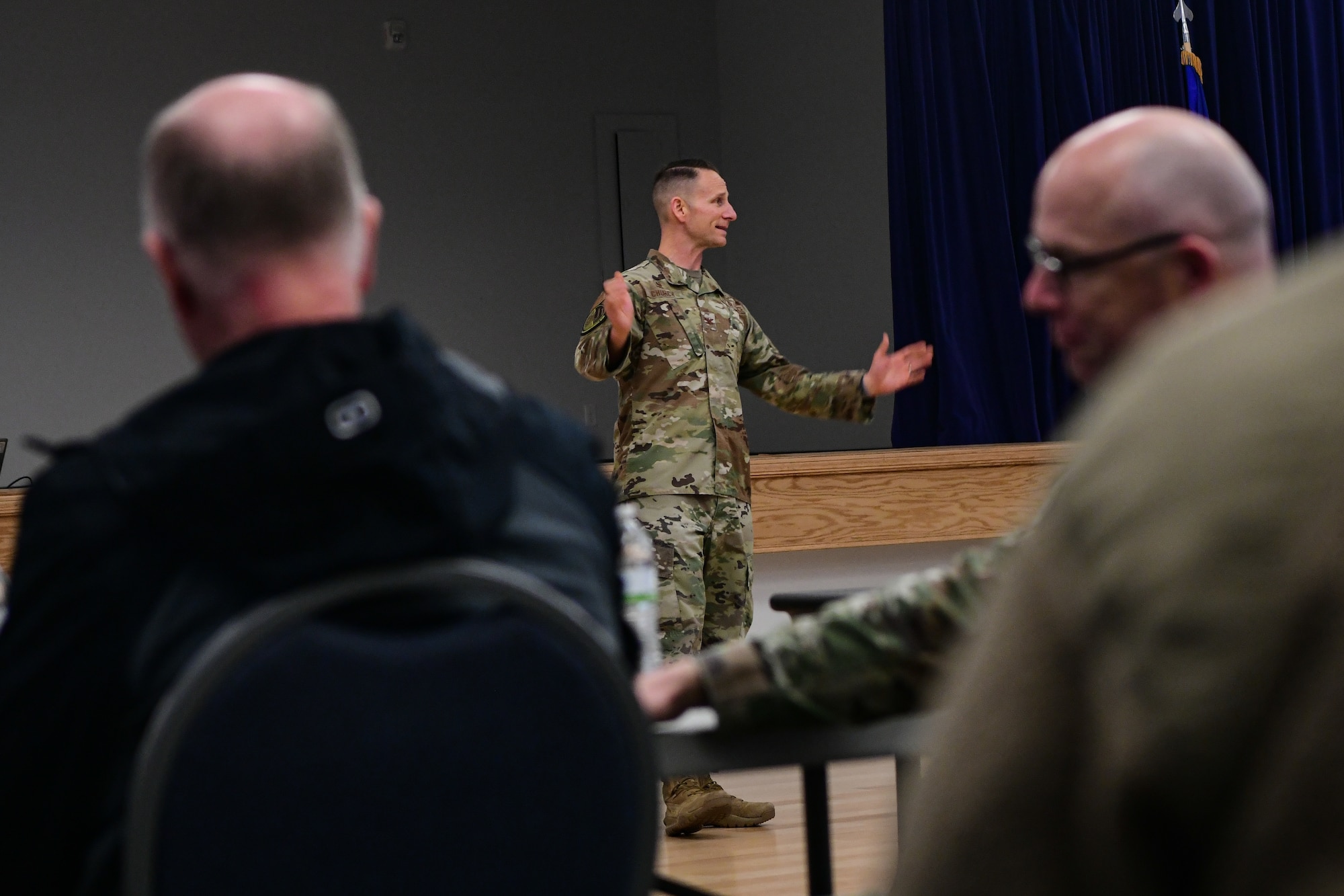 U.S. Air Force Col. Geoffrey Church, 9th Reconnaissance Wing commander, briefs the newly appointed honorary commanders during the immersion tour at the Community Activity Center on Beale Air Force Base, Calif., Feb. 24, 2023.