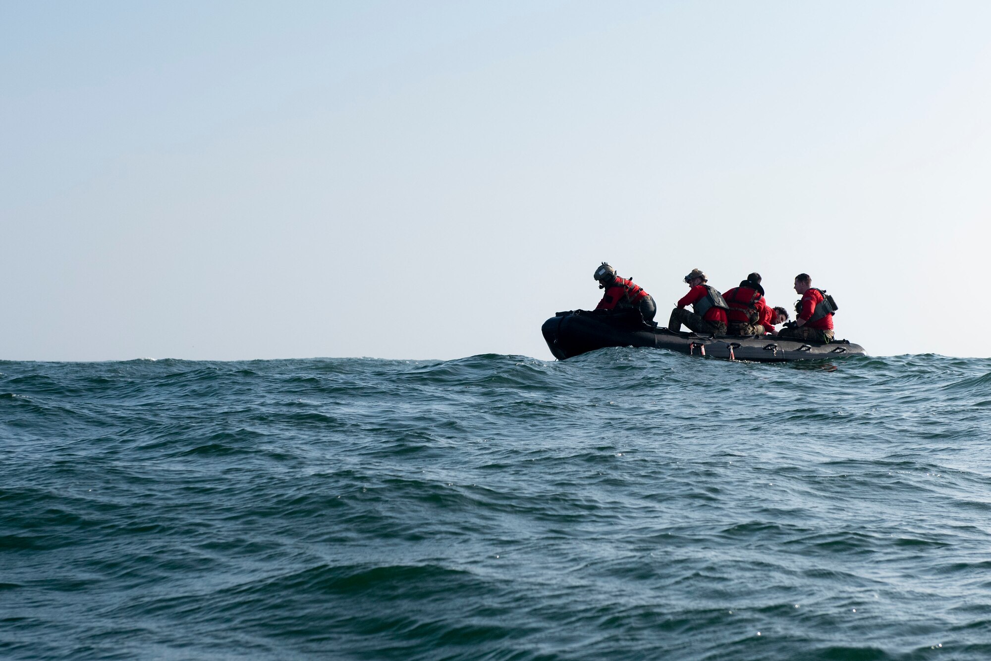 Pararescuemen operate a boat