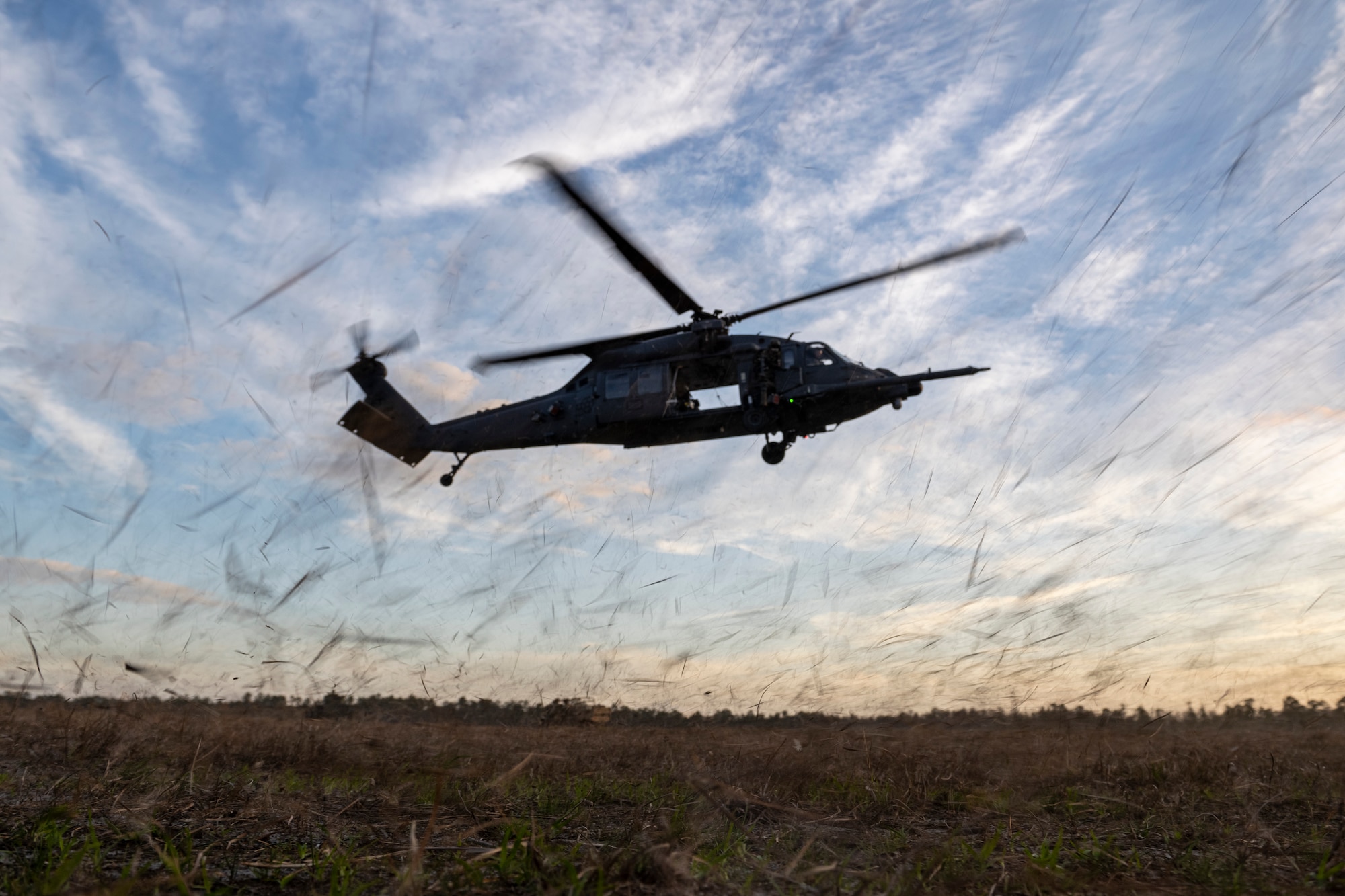 An HH-60W Jolly Green II lands at Grand Bay Bombing and Gunnery Range during a deployment readiness exercise