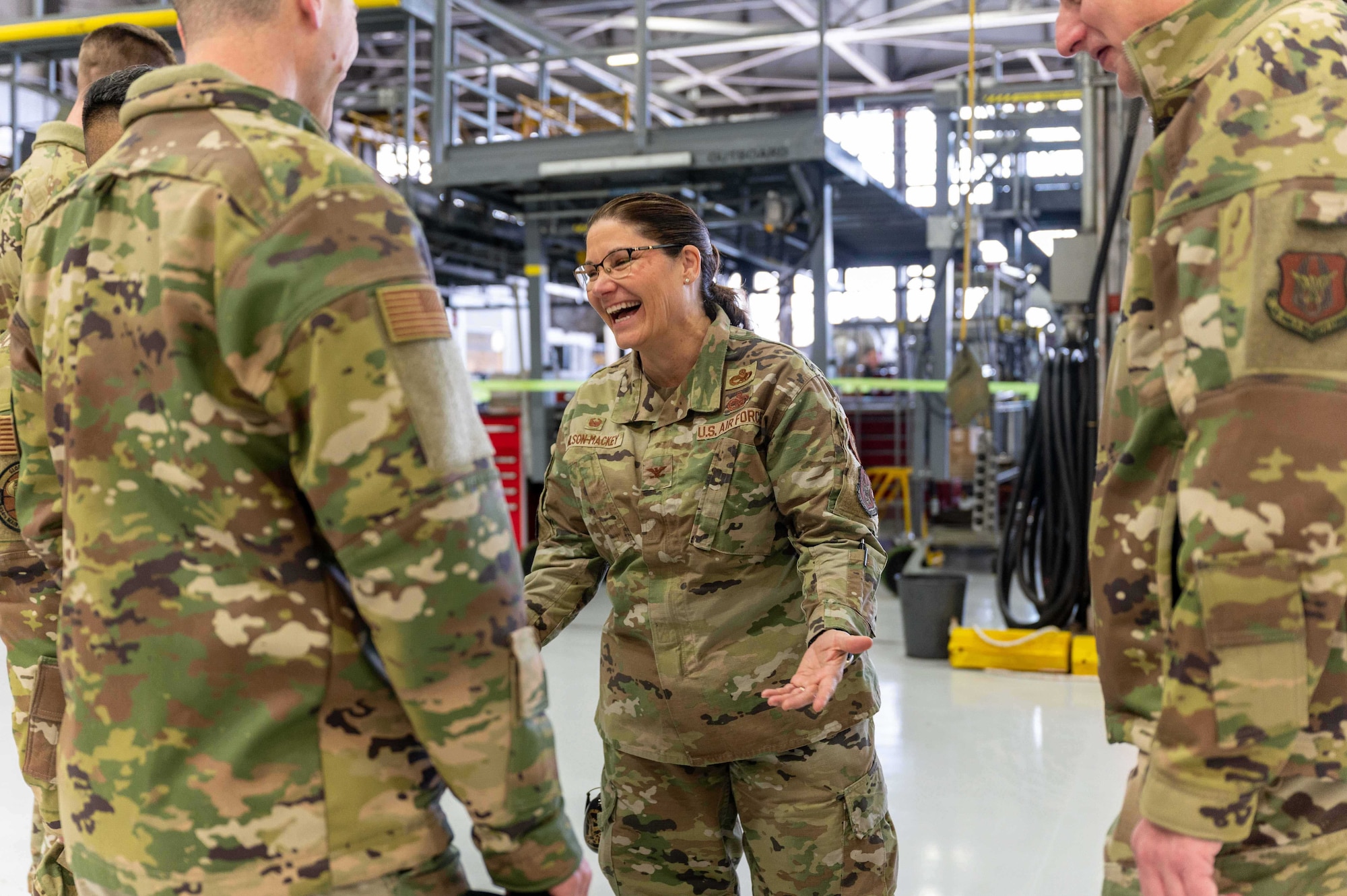 Colonel Gia Wilson-Mackey, 934th Maintenance Group commander, shares a laugh with some Airmen inside the hangar at the Minneapolis-St. Paul Air Reserve Station, Feb. 25, 2023. Wilson-Mackey will officially assume command during the March UTA. (U.S. Air Force photo by Master Sgt. Trevor Saylor)