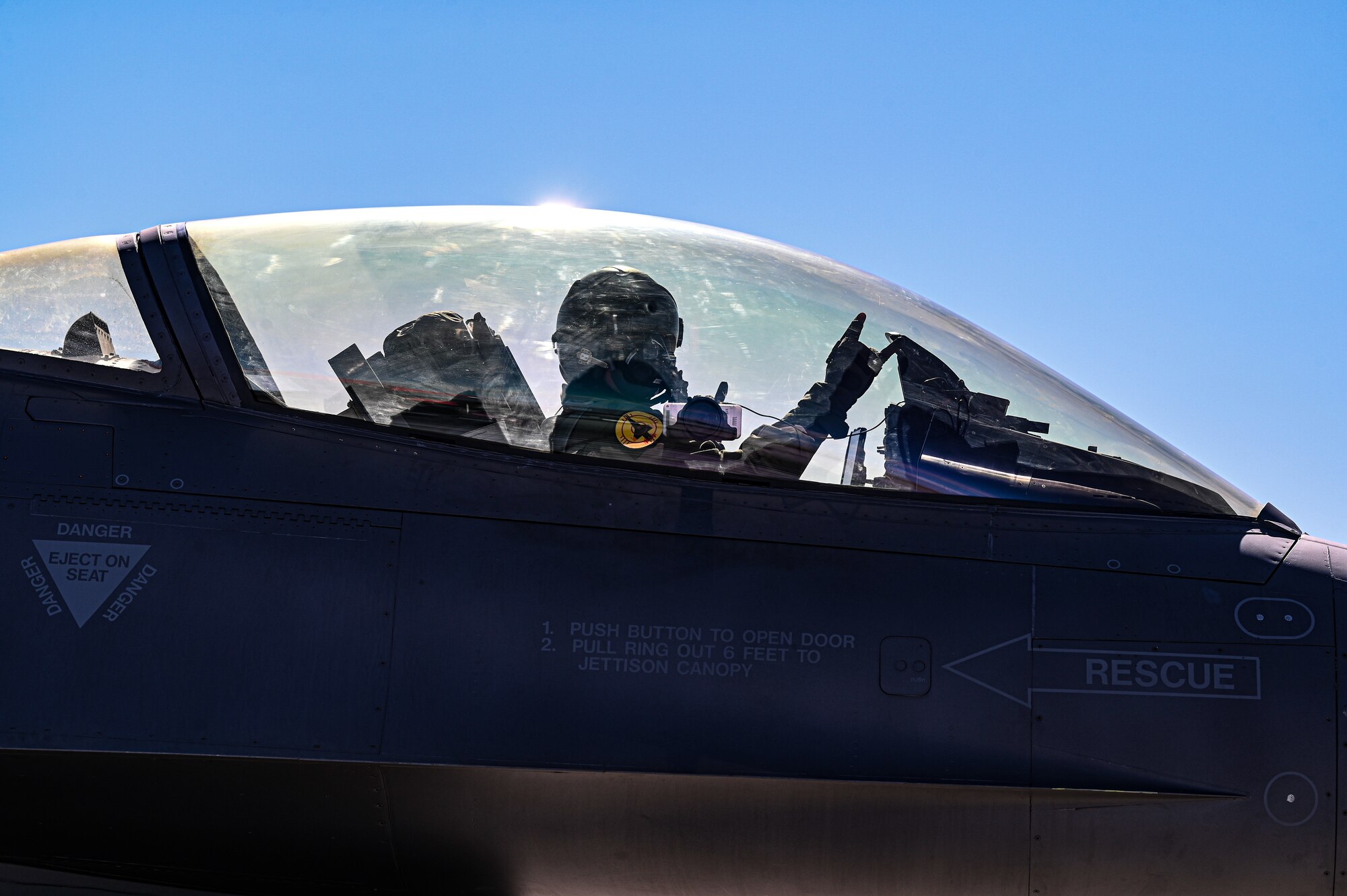 U.S. Air Force Lt. Col. John Harris, 82nd ATRS Detachment 1 commander throws a rock hand symbol before takeoff at Holloman Air Force Base, New Mexico, Feb. 22, 2023. The detachment stationed at Holloman is a part of the 53rd Weapons Evaluation Group at Tyndall Air Force Base. (U.S. Air Force photo by Airman 1st Class Isaiah Pedrazzini)