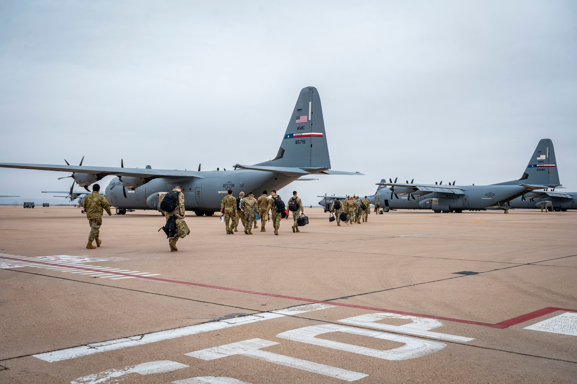 U.S. Air Force Airmen assigned to the 317th Airlift Wing walk on the flightline towards a C-130J Super Hercules before leaving for a deployment at Dyess Air Force Base, Texas, Feb. 25, 2023. Members from the 317th were deployed to the Middle East in support of the U.S. Central Command’s continued mission of enabling military operations and activities with allies and partners to increase regional security and stability in support of enduring U.S. interests. (U.S. Air Force photo by Senior Airman Leon Redfern)