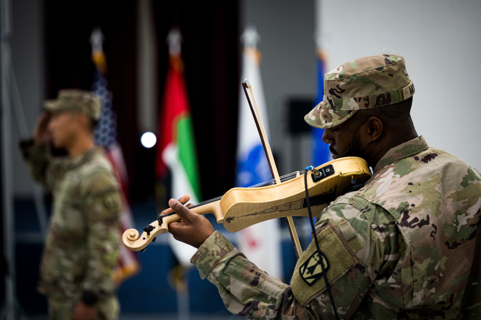 U.S. Army Sgt. 1st Class Myles Moore, assigned to the 4th Battalion 3rd Air Defense Artillery Regiment (4-3 ADA), performs the U.S. National Anthem on the violin during the 4-3 ADA transfer of authority ceremony, Jan. 26, 2023. The 4-3 ADA transferred responsibility of the MIM-104 Patriot missile systems at Al Dhafra AB to the 2nd Battalion 43rd Air Defense Artillery Regiment before returning to garrison at Ft. Sill, Oklahoma.