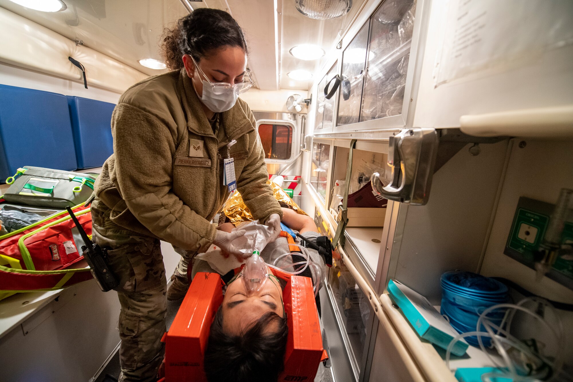 U.S. Air Force Senior Airman Yanill Pierna Rodriguez, 51st Medical Group (MDG) emergency medical technician, delivers oxygen to Kwang Pil Pak, 51st MDG warrior medicine clinic administrator and simulated trauma patient, in the back of an ambulance enroute to urgent care on Osan Air Base, Republic of Korea, Feb. 28, 2023. Pierna Rodriguez treated the simulated patient who was a victim of multiple stab wounds. (U.S. Air Force photo by Airman 1st Class Aaron Edwards)