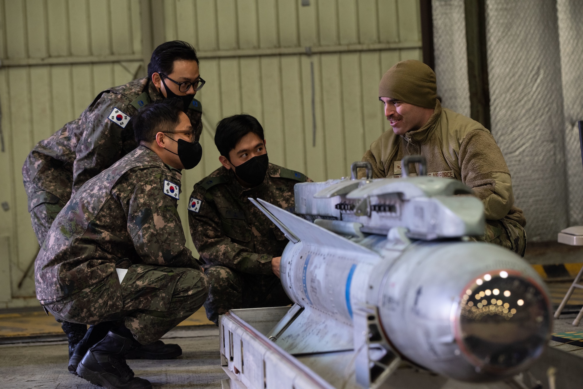 U.S. Air Force Senior Airman Wesley Miles, 51st Maintenance Group squadron lead crew member, explains the various components of a TGM-65 air-to-ground missile during an immersion tour for Republic of Korea Air Force interpretation officers in training at Osan Air Base, ROK, Feb. 23, 2023.