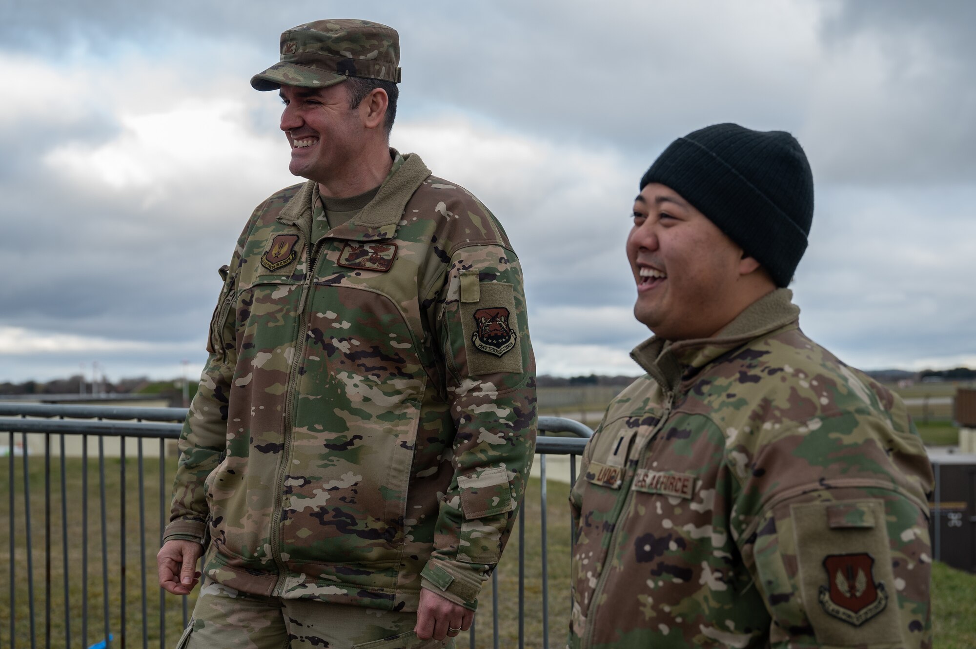 U.S. Air Force Col. Gene Jacobus, left, 100th Air Refueling Wing commander, and 1st Lt. Aris Livica, right, 100th Logistics Readiness Squadron section commander, watches others being hoisted out of an emptied jet fuel storage tank, Feb. 28, 2023, at Royal Air Force Mildenhall, England.