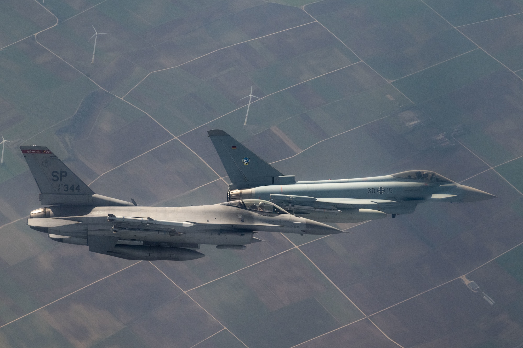 A U.S. Air Force F-16 Fighting Falcon assigned to the 480th Fighter Squadron at Spangdahlem Air Base, Germany (left), flies alongside a German air force Eurofighter Typhoon assigned to the 74th Tactical Air Wing over Germany, Feb. 16, 2023.