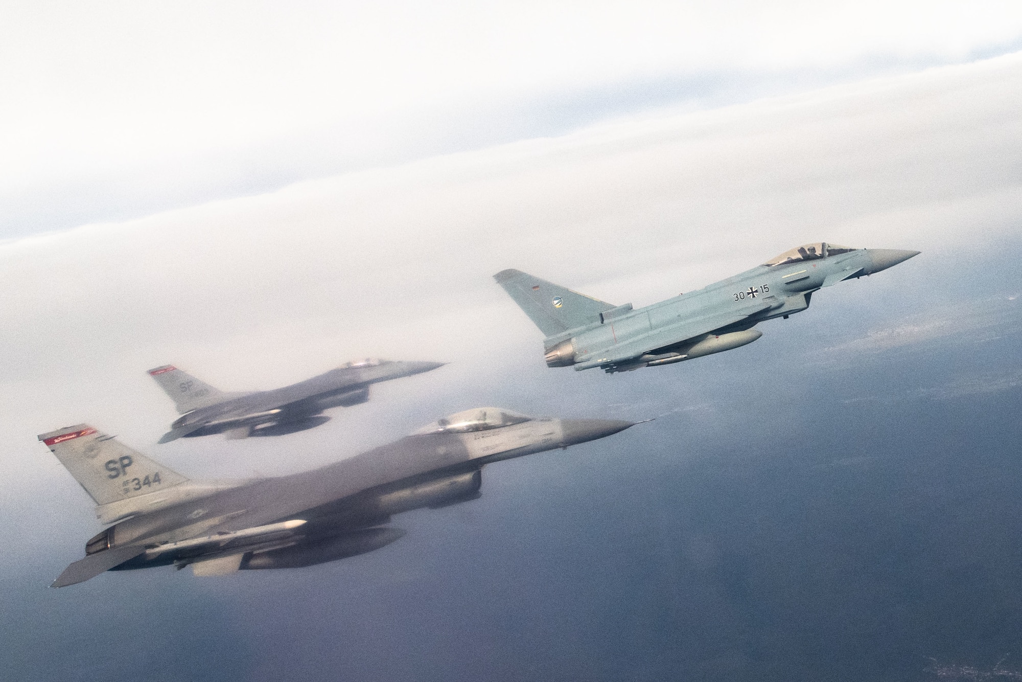 U.S. Air Force F-16 Fighting Falcon assigned to the 480th Fighter Squadron at Spangdahlem Air Base, Germany, fly alongside a German air force Eurofighter Typhoon assigned to the 74th Tactical Air Wing over Germany, Feb. 16, 2023.