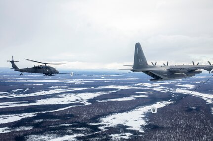 An HC-130J Combat King II aircraft of the 211th Rescue Squadron, Alaska Air National Guard, refuels an HH-60G Pave Hawk helicopter of the 210th Rescue Squadron during training over Joint Base Elmendorf-Richardson, March 23, 2020.