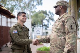 Staff Sgt. Elad Koren with the Israel Defense Forces shakes hands with Col. Gerri Jackson with the 143d Expeditionary Sustainment Command during Juniper Falcon 2023, Feb. 9, 2023. JF23 is a bilateral exercise designed to improve the cooperative defense of Israel between the U.S. and the Israeli Defense Forces.