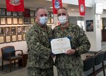 U.S. Navy Commander David Bennett, deputy director for Naval Medical Center Camp Lejeune Branch Clinics, left, was recognized for his heroic actions that saved a life.