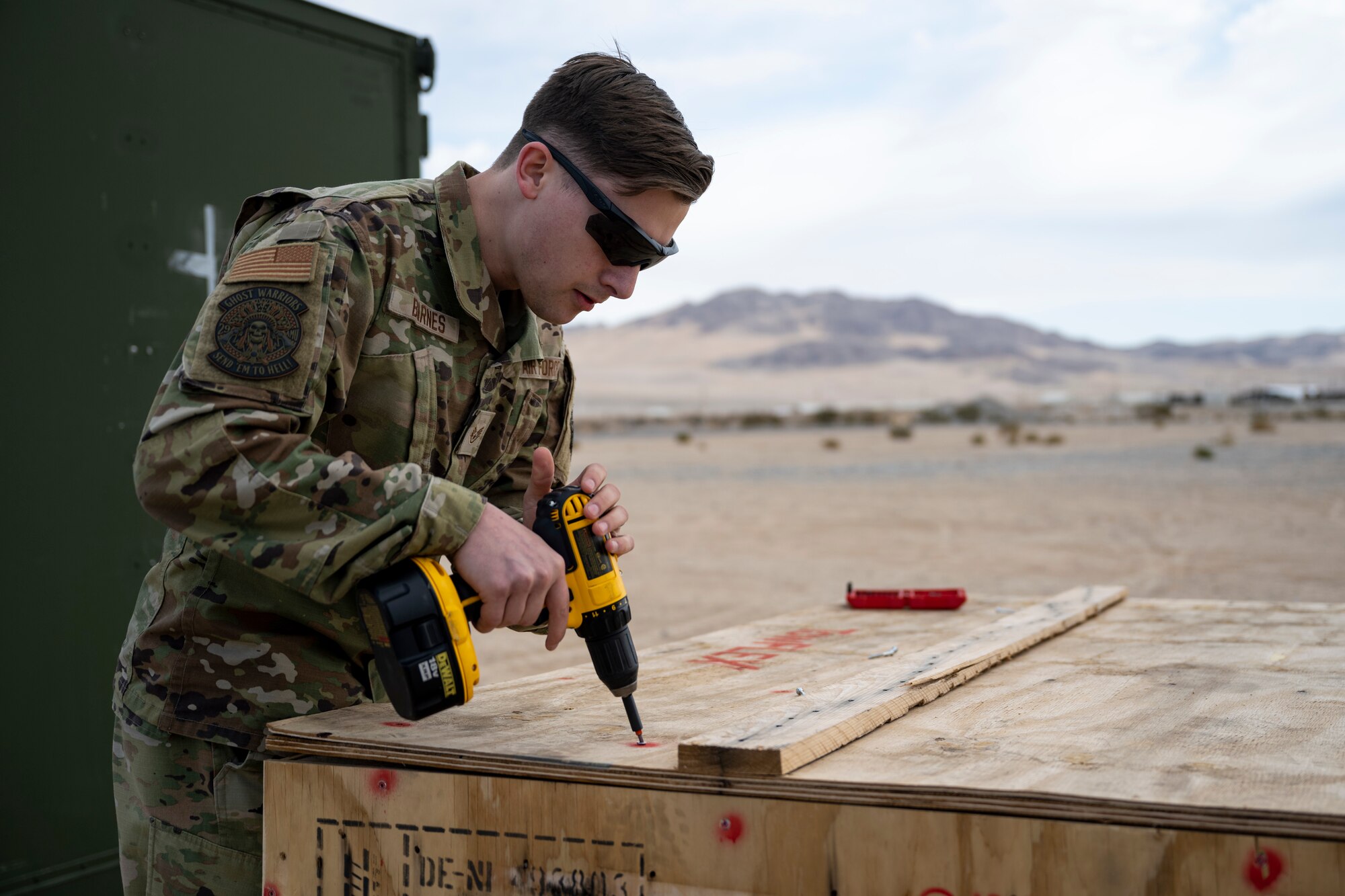 U.S. Air Force Staff Sgt. Camden Barnes, 29th Aircraft Maintenance Squadron avionics system technician, unboxes a TowFLEXX TF3 aircraft tug at Marine Corps Air Ground Combat Command Center, Twentynine Palms, California, Feb. 13, 2023. Airmen from Holloman Air Force Base, Cannon AFB, N.M., and Creech AFB, Nevada, participated in Agile Combat Employment Reaper 23.6 at Twentynine Palms to hone their skills while also supporting RPA training for Marines stationed there. (U.S. Air Force photo by Staff Sgt. Kristin West)