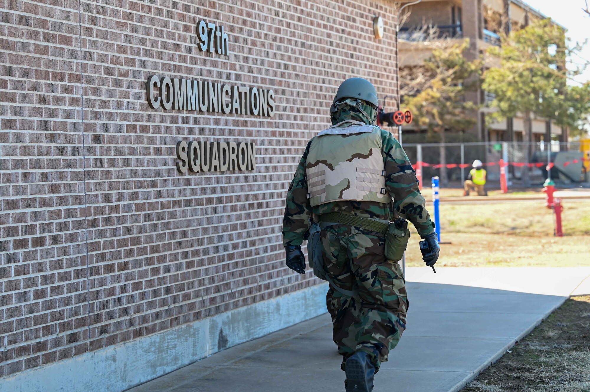 Lt. Col. Colby Arends, 97th Communications Squadron (CS) commander, continues his sweep of the grounds during a readiness exercise at Altus Air Force Base, Oklahoma, Feb. 23, 2023.The 97 CS Airmen kicked off their readiness training by donning mission-oriented protective posture level-four gear while completing their daily tasks, ensuring accountability, and doing a simulated sweep to detect and report any unidentified objects. (U.S. Air Force photo by Airman1st Class Kari Degraffenreed)