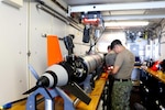 SEA OF JAPAN (May 13, 2022) Members from Explosive Ordnance Disposal Mobile Unit (EODMU) 11 embarked on the Independence-class littoral combat ship USS Charleston (LCS 18) conduct maintenance on the MK 18 MOD 2 Kingfish during Exercise Noble Vanguard. The Kingfish is an unmanned underwater vehicle with the sonar capabilities to scan the ocean floor for potential mines. Noble Vanguard serves as an enabler to reinforce tactics and techniques of different mission sets that contribute to regional stability. (U.S. Navy Photo by Ensign James French)