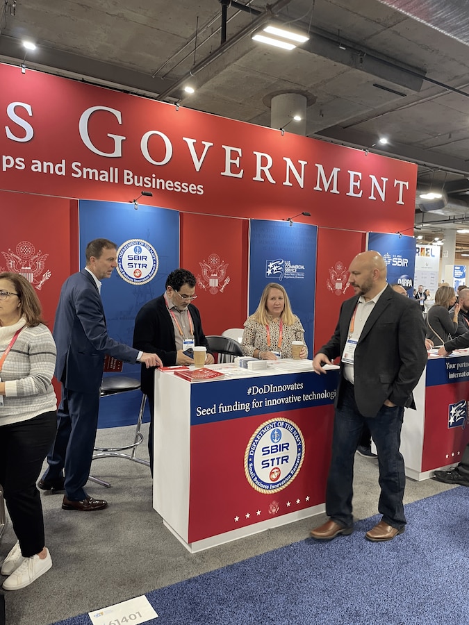 Navy Tabletop at USG Resources for Startups and Small Businesses at CES 2023, Las Vegas, Nevada

Pictured Left to Right: Brian Shipley (Navy SBIR/STTR Commercialization PM), Antonio Rodriguez (Contractor Support), Megan Stokes (Contractor Support), and Michael Pyryt (Navy SSP SBIR/RIF PM).