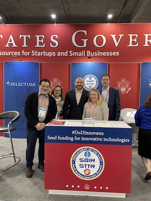 Navy Tabletop at USG Resources for Startups and Small Businesses at CES 2023, Las Vegas, Nevada

Pictured Left to Right: Antonio Rodriguez (Contractor Support), Kathy Fontana (Contractor Support), Michael Pyryt (Navy SSP SBIR/RIF PM), Megan Stokes (Contractor Support), and Brian Shipley (Navy SBIR/STTR Commercialization PM)