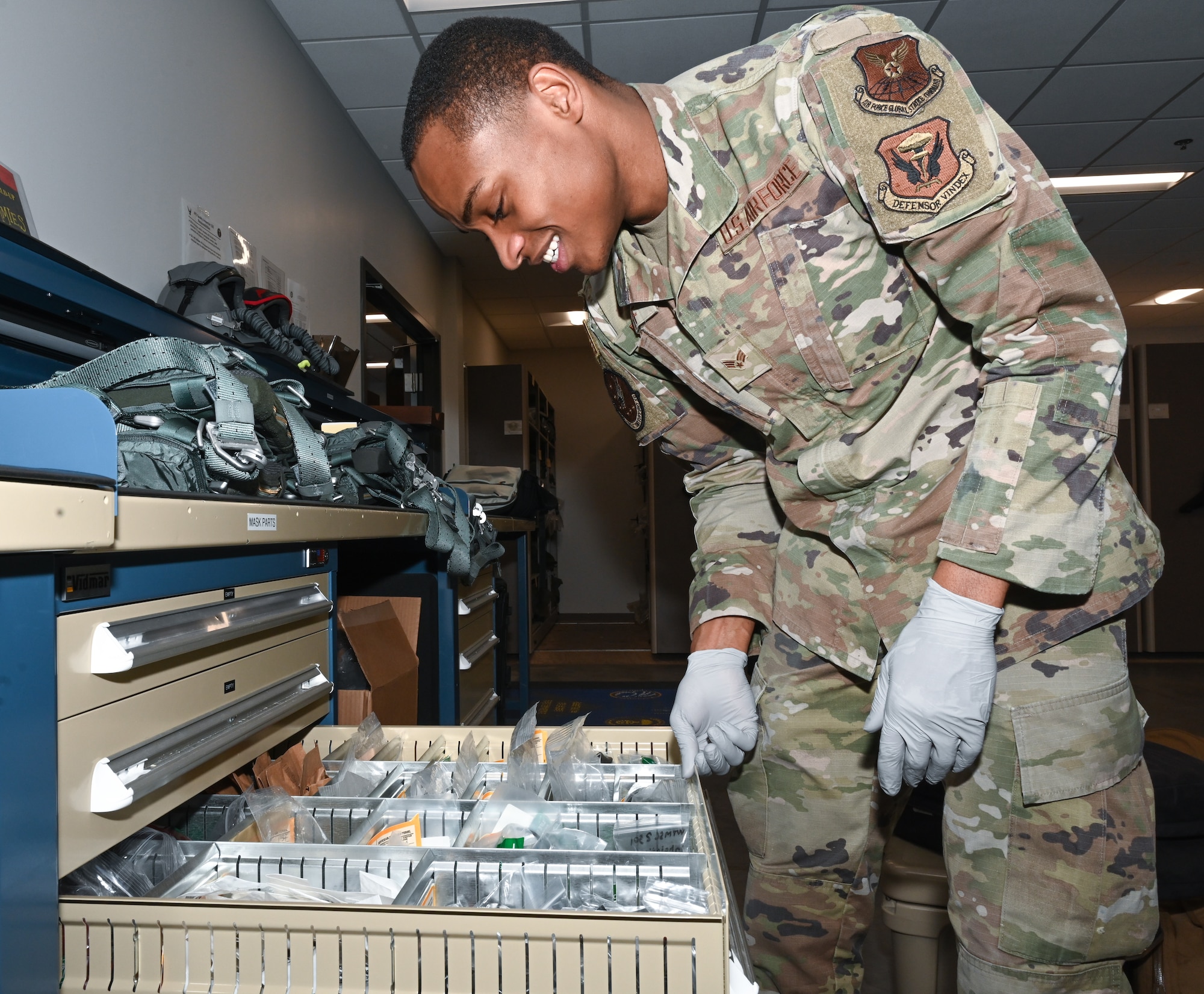 Senior Airman Anthony Ratliff, Aircrew Flight Equipment journeyman, assigned to the 509th Operations Support Squadron, gathers tools to perform a routine inspection on an aircrew member’s HGU-55p helmet and MBU-20p mask at Whiteman Air Force Base, Missouri, Feb. 13, 2023. The attention to detail provided by AFE Airmen could mean the difference between life and death for aircrew members. (U.S. Air Force photo by Airman 1st Class Hailey Farrell)