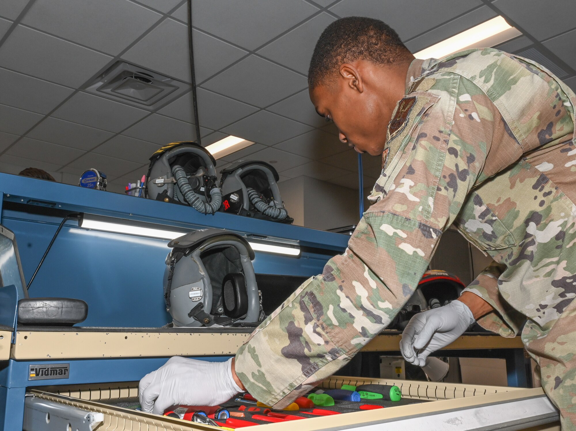Senior Airman Anthony Ratliff, Aircrew Flight Equipment journeyman, assigned to the 509th Operations Support Squadron, gathers tools to perform a routine inspection on an aircrew member’s HGU- 55p helmet and MBU-20p mask at Whiteman Air Force Base, Missouri, Feb. 13, 2023. This process is completed by AFE Airmen every 30 days to ensure the flight equipment is in good working order. (U.S. Air Force photo by Airman 1st Class Hailey Farrell)
