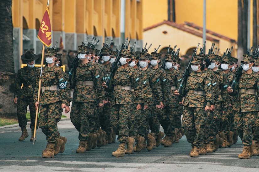 Service members march in formation.