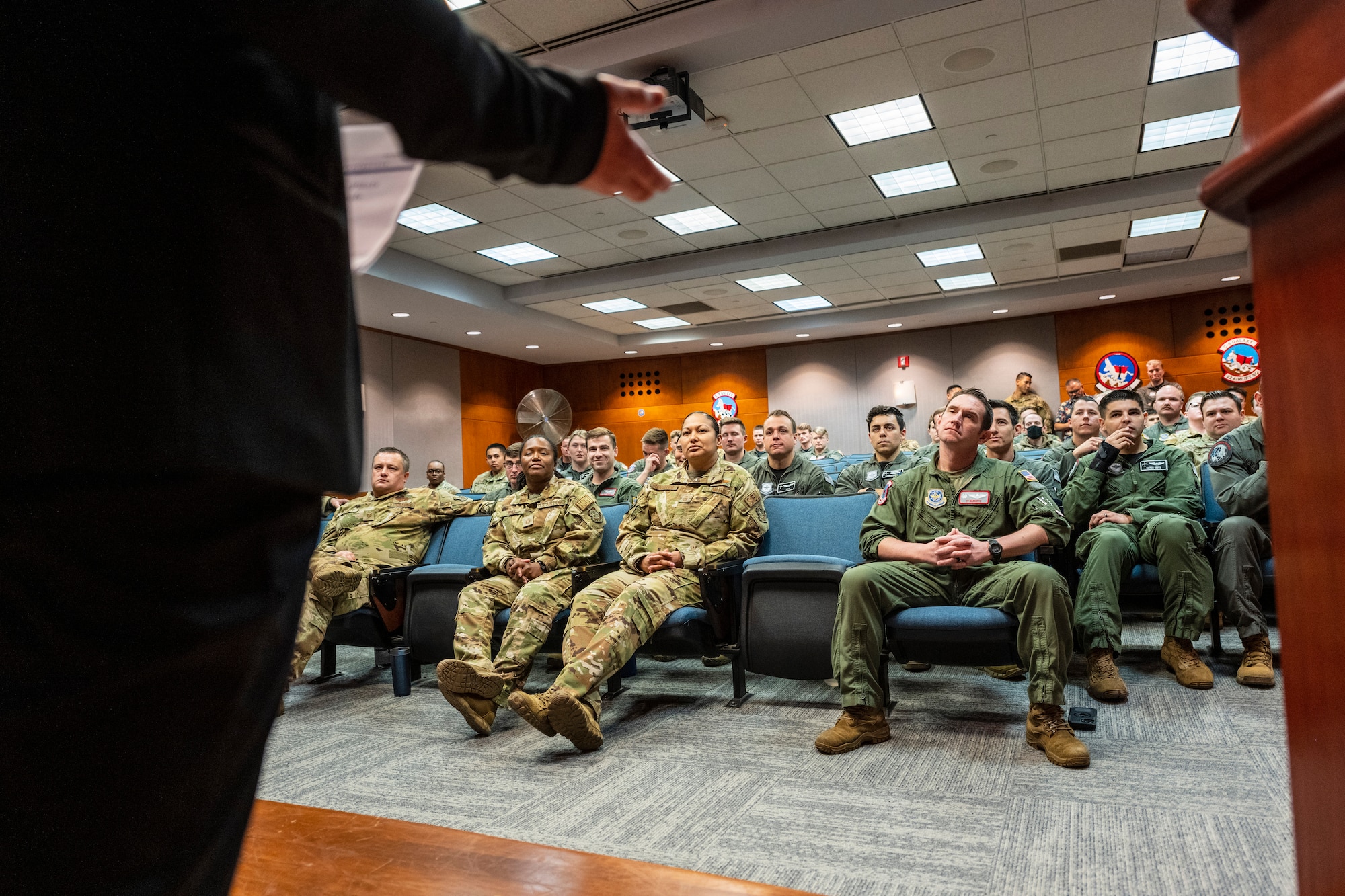 A person stands at the front of an audience.