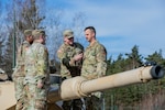 U.S. Army Staff Sgt. Angelo E. Gelster, an ammunition specialist assigned to Task Force Orion, 27th Infantry Brigade Combat Team, New York Army National Guard, is promoted during a ceremony atop an M1A2 Abrams tank in Grafenwoehr, Germany, Feb. 20, 2023. Gelster, a former armor crewmember who operated M1A1 Abrams tanks with the now-disbanded 127th Armor Regiment, is deployed to Germany in support of the Joint Multinational Training Group – Ukraine mission to ensure the combat effectiveness of Ukrainian military personnel training in Germany.