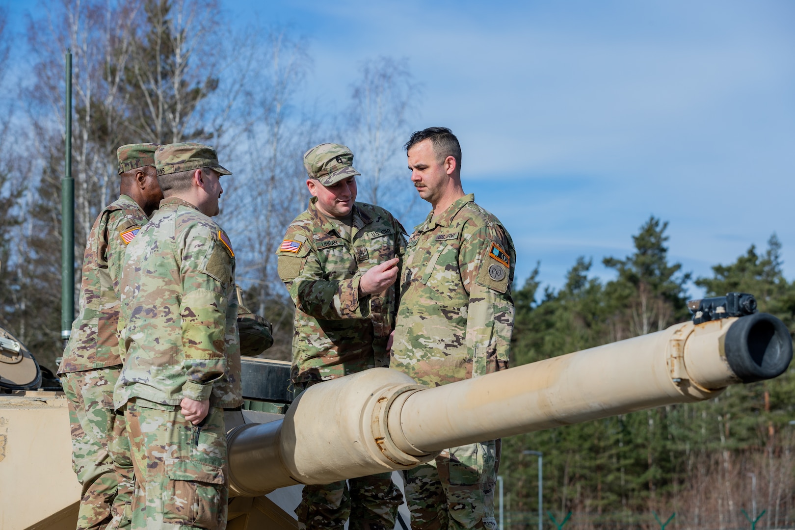 U.S. Army Staff Sgt. Angelo E. Gelster, an ammunition specialist assigned to Task Force Orion, 27th Infantry Brigade Combat Team, New York Army National Guard, is promoted during a ceremony atop an M1A2 Abrams tank in Grafenwoehr, Germany, Feb. 20, 2023. Gelster, a former armor crewmember who operated M1A1 Abrams tanks with the now-disbanded 127th Armor Regiment, is deployed to Germany in support of the Joint Multinational Training Group – Ukraine mission to ensure the combat effectiveness of Ukrainian military personnel training in Germany.