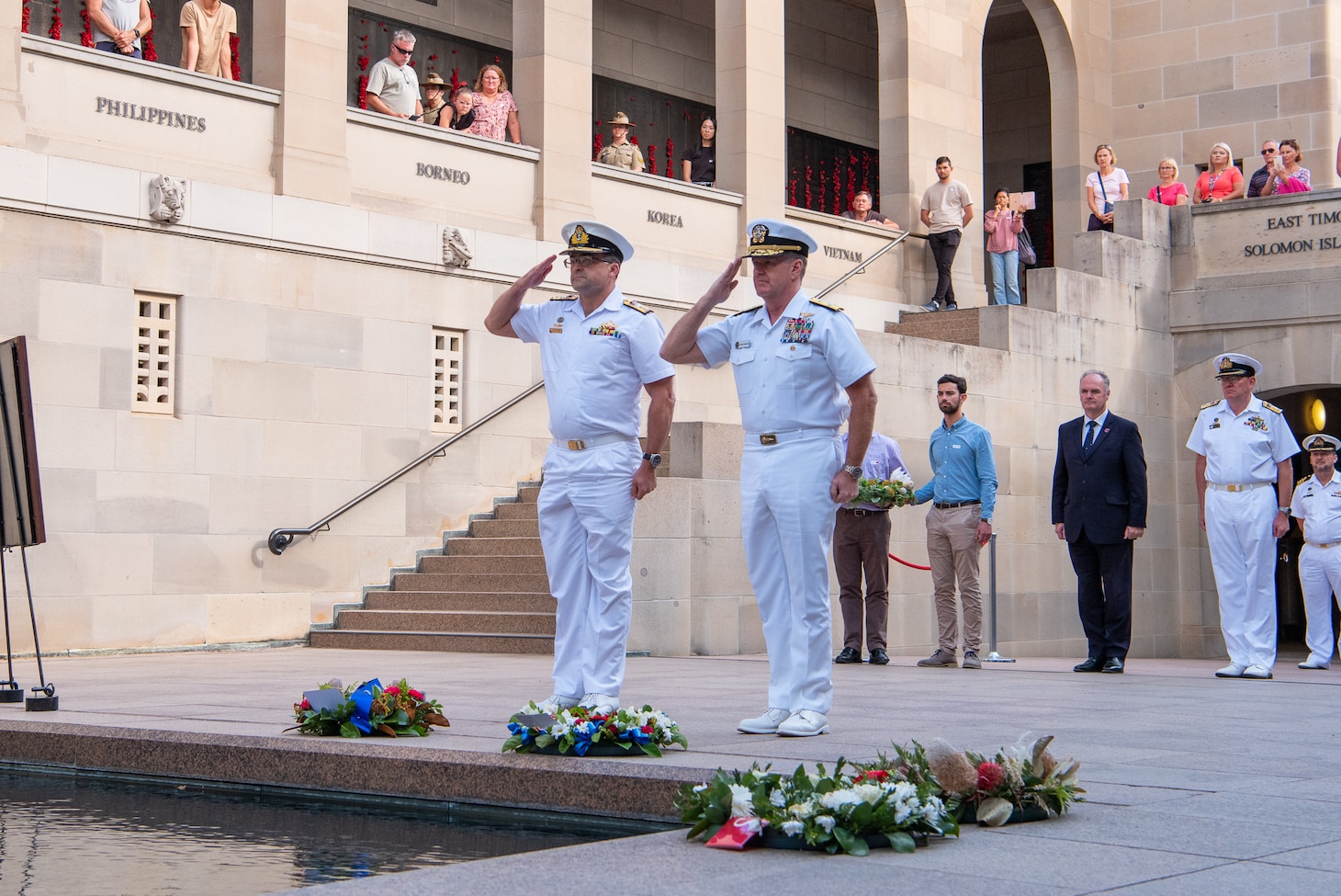 Adm. Samuel Paparo salutes after laying a wreath during the Last Post Ceremony at the Australian War Memorial.