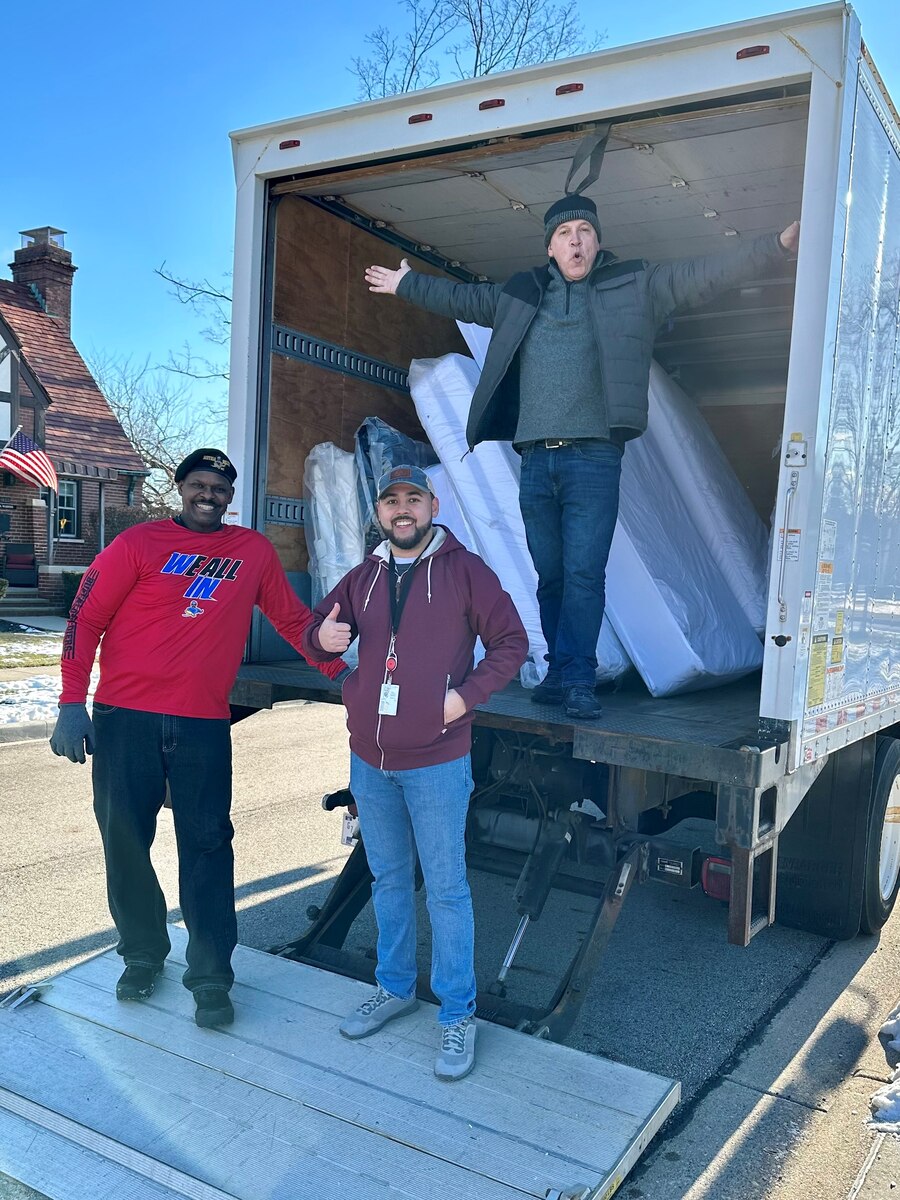 From left, Darryl McFadden, Isaiah Kleiner and Patrick Solberg, volunteers with The Aviation Chapter for the American Society of Military Comptrollers, unload mattresses from storage to furnish Fisher House I Jan. 27 at Wright-Patterson Air Force Base, Ohio. Volunteers helped prepare the house for guests after a yearlong renovation project.