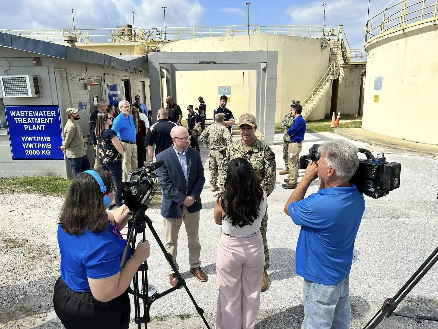 people with video cameras and microphone talk with Naval Station Mayport personnel