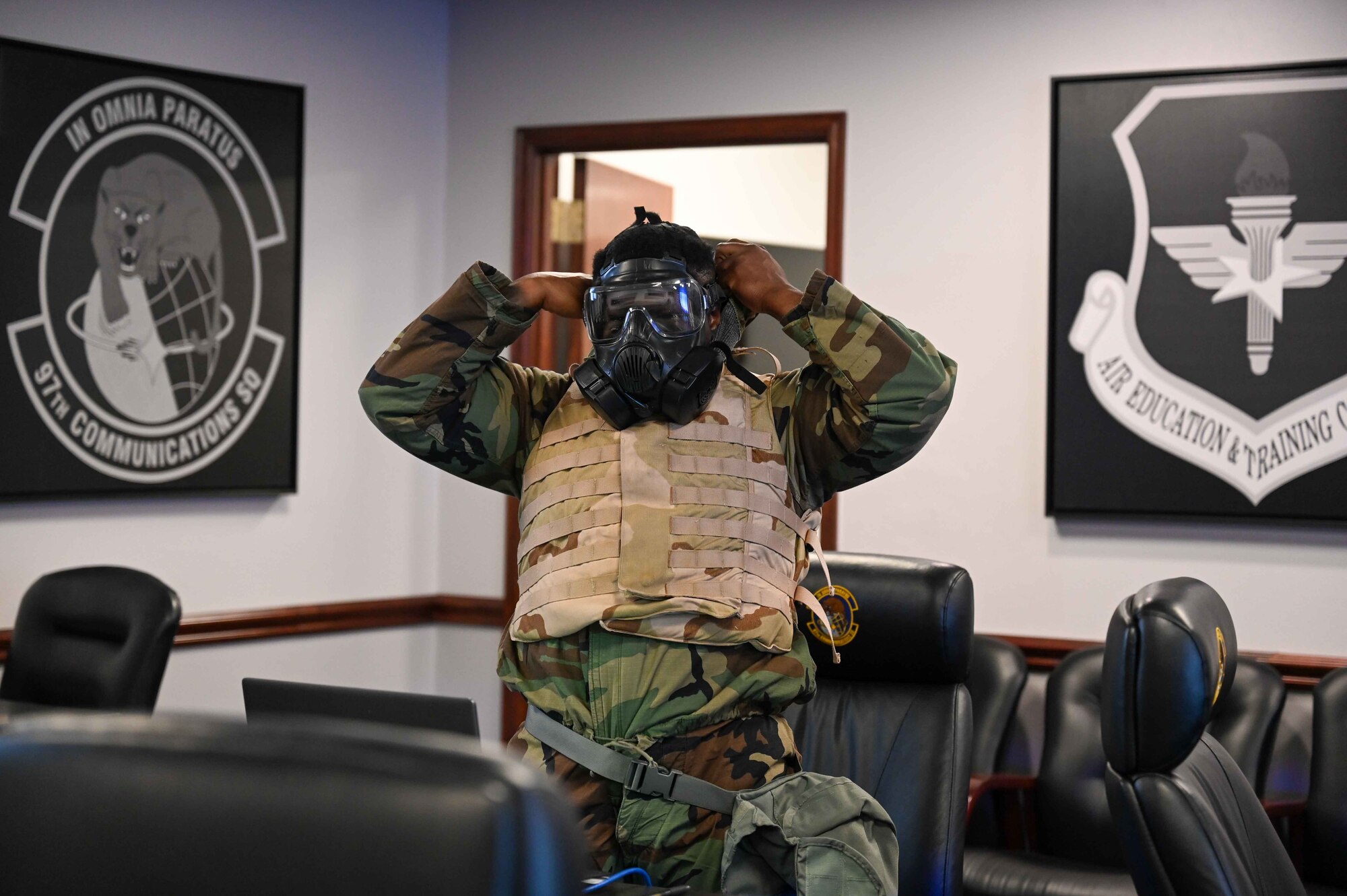U.S. Air Force Tech. Sgt. Tristan Bradsher, 97th Communications Squadron (CS)noncommissioned officer in charge of wing cyber security, puts his mask on for mission-oriented protective posture (MOPP) level three at Altus Air Force Base, Oklahoma, Feb. 23, 2023. MOPP gear is used to prepare for chemical, biological, radiological and nuclear attacks. (U.S. Air Force photo by Airman 1st Class Kari Degraffenreed)